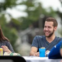 candid photo of man and woman laughing around a table
